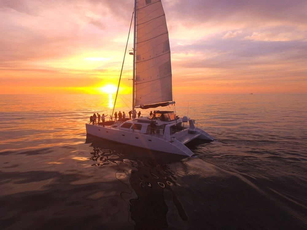 Private group charter sailing into the sunset along Jamaica's coast